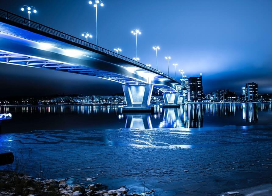 city bridge with bright lights at night