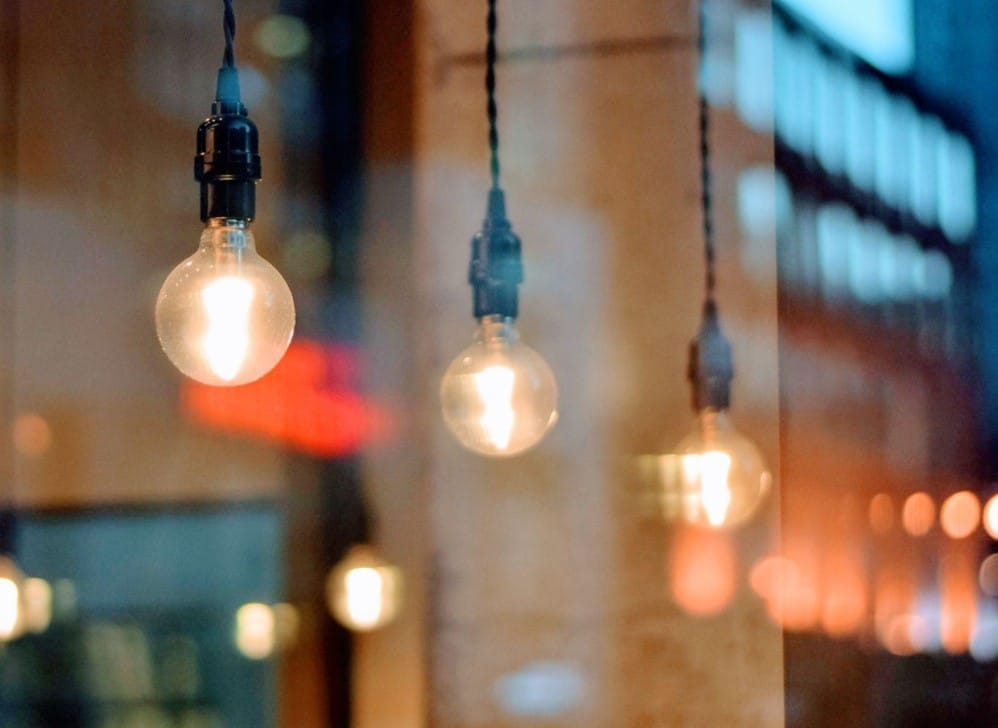 close-up of lightbulbs against the city in the background
