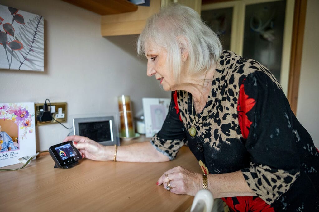 lady checking energy consumption in her home using smart meter