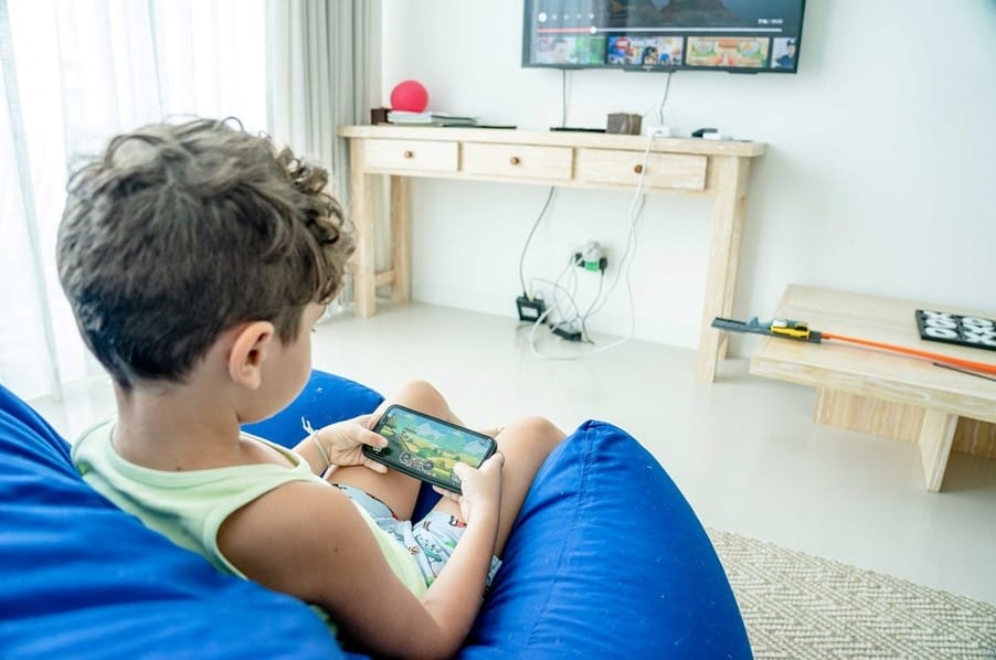 child playing game on mobile