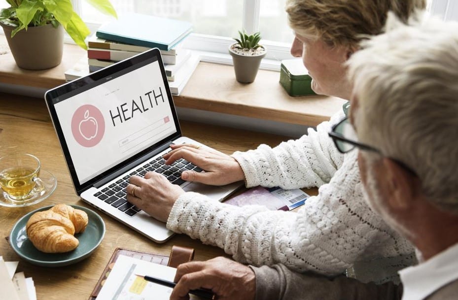 old couple checking health on laptop