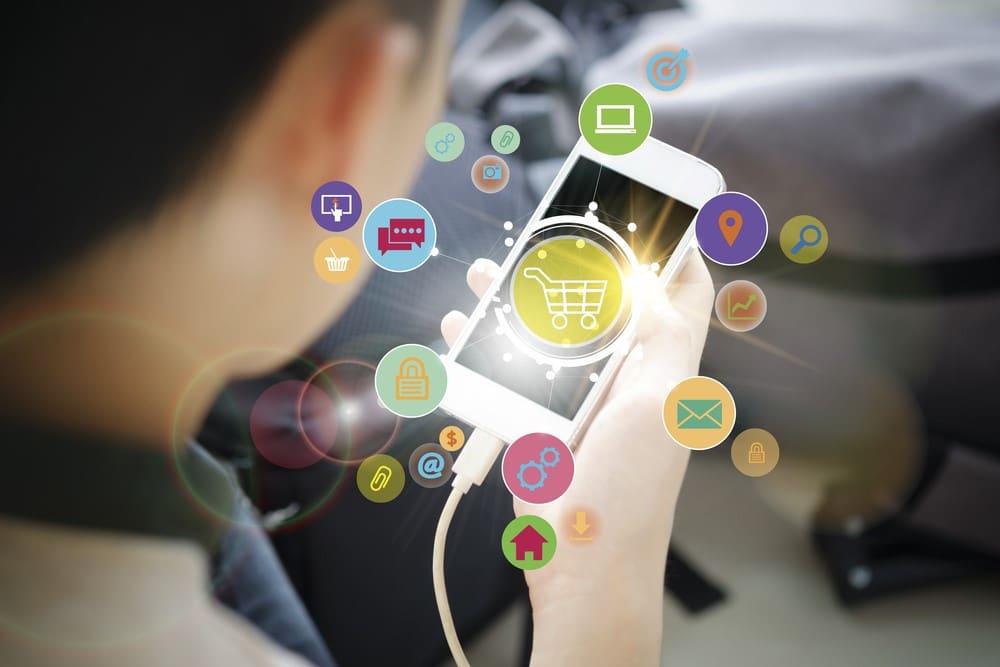 Person holding phone with shopping cart icon
